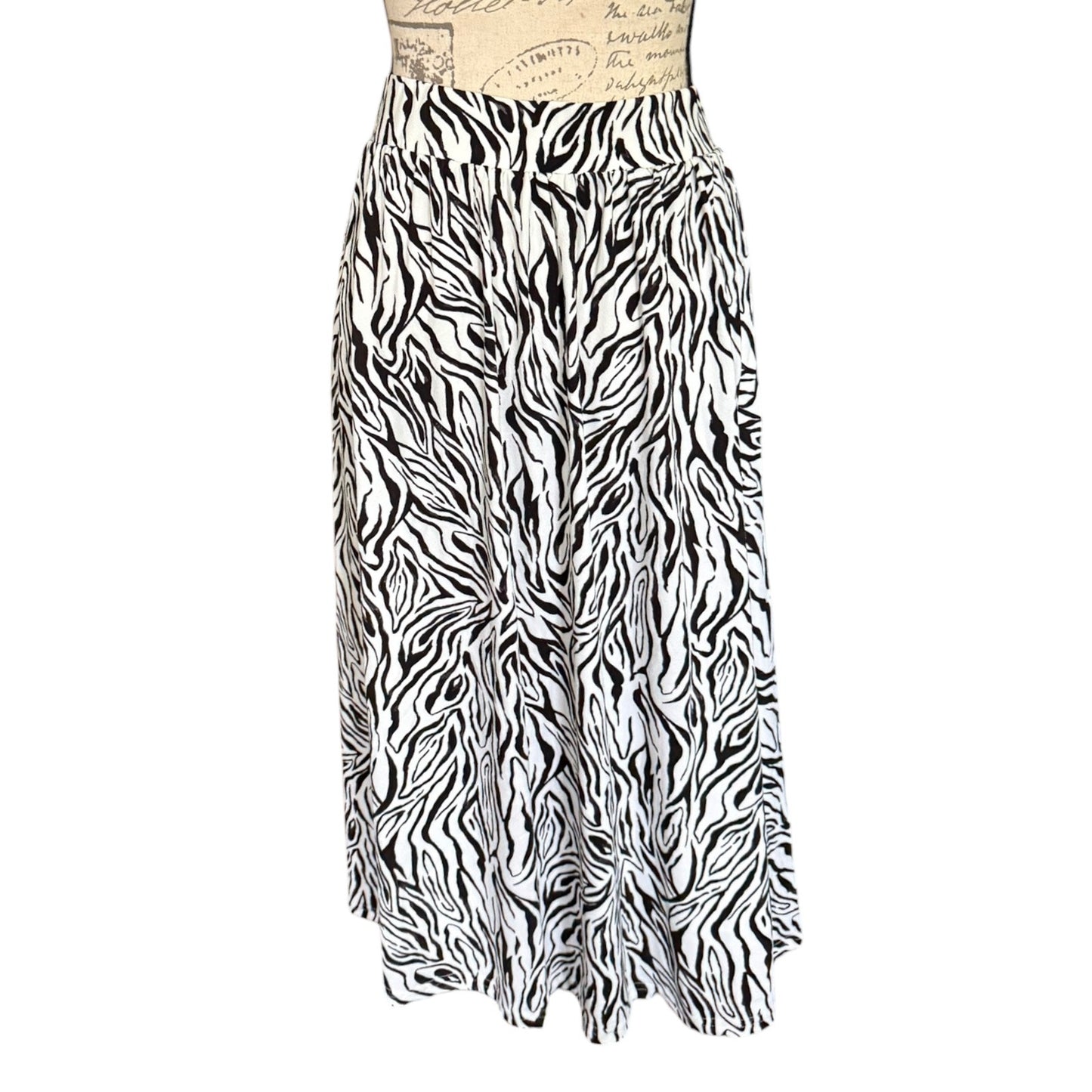 Black and white zebra print skirt on a mannequin against a white background