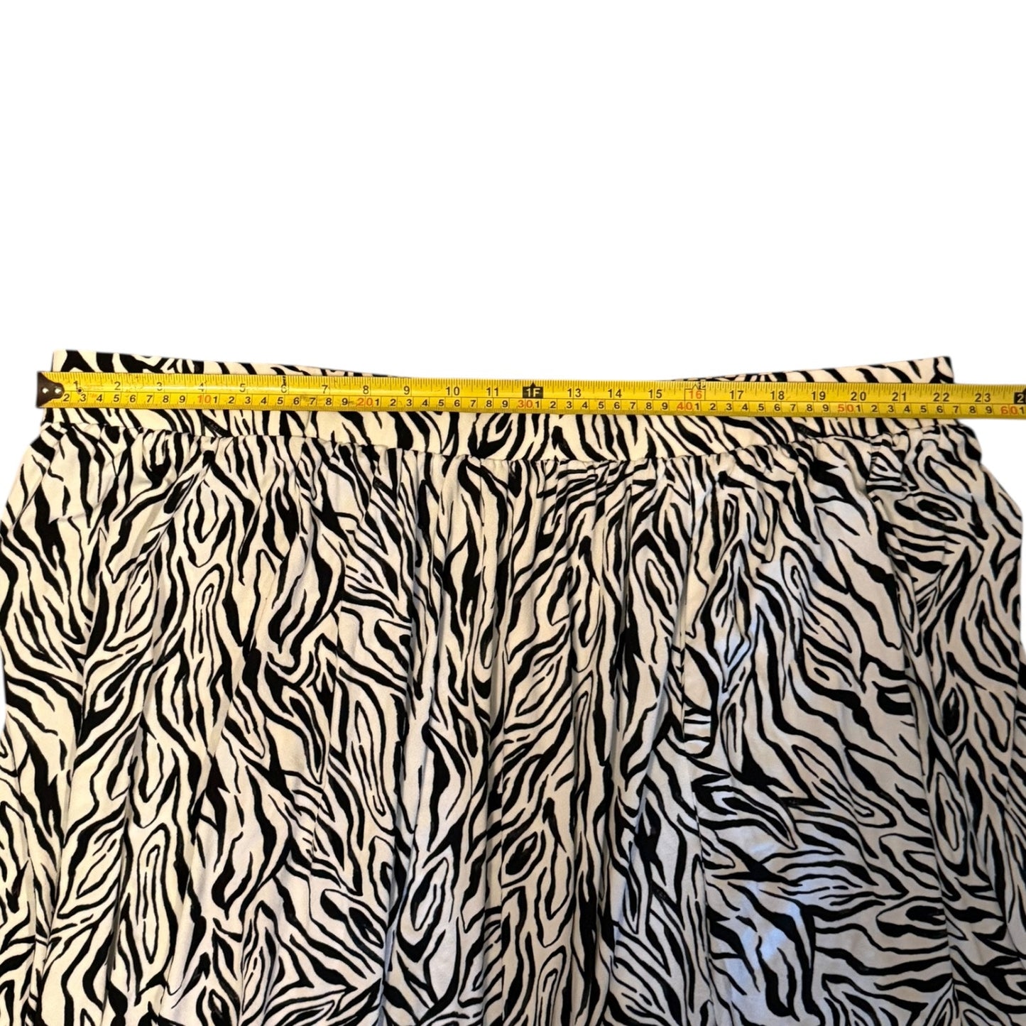 Zebra skirt fabric with a measuring tape indicating its width