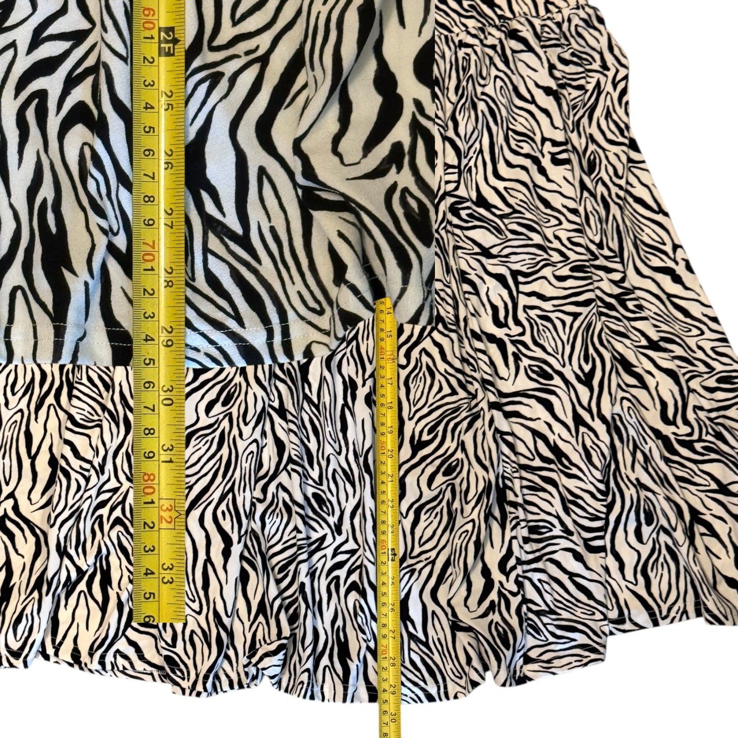 Zebra print skirt with a measuring tape for scale on a white background
