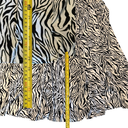 Zebra print skirt with a measuring tape for scale on a white background