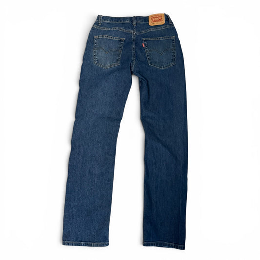Blue jeans with a brand label on the back pocket against a white background