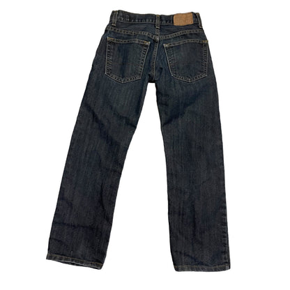 Back of a Pair of dark blue jeans on a white background