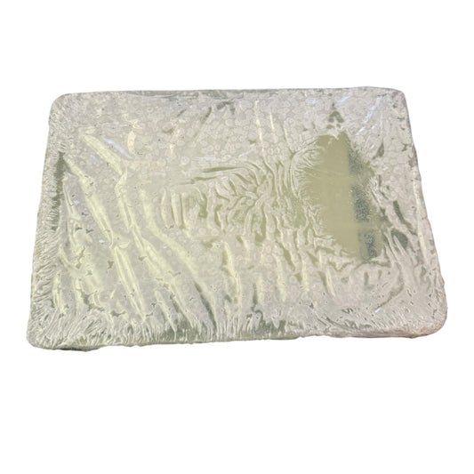 Rectangular bar of soap with textured surface on a white background