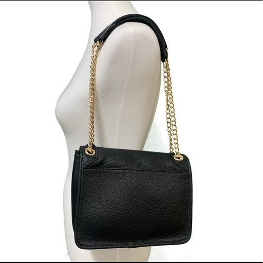 Back of Black handbag with gold chain strap on a mannequin against a white background