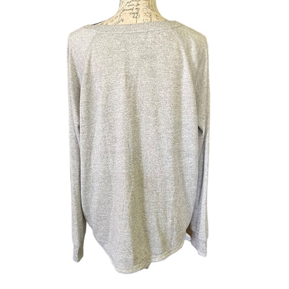Back of Light gray shirt on a mannequin against a white background