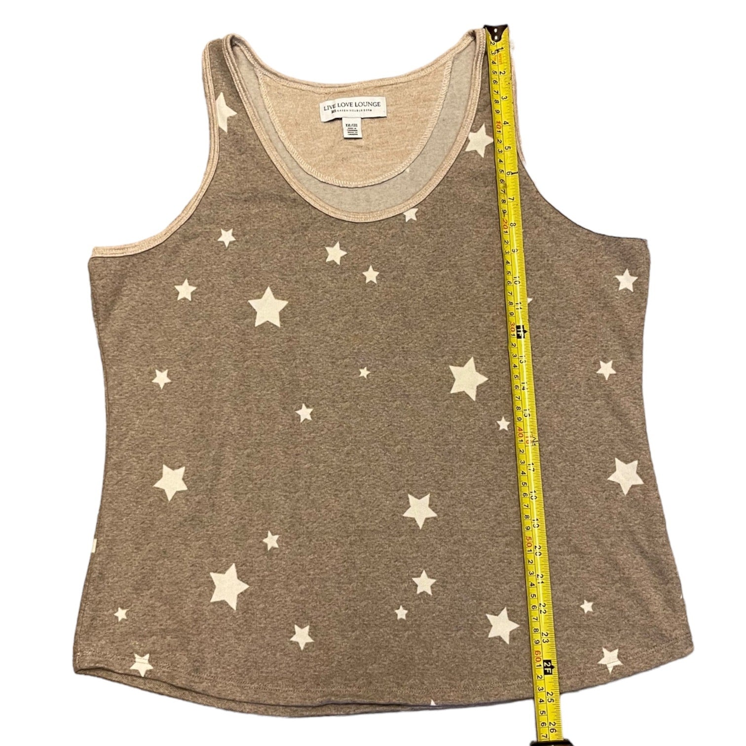Brown tank top with star patterns and a measuring tape on a white background