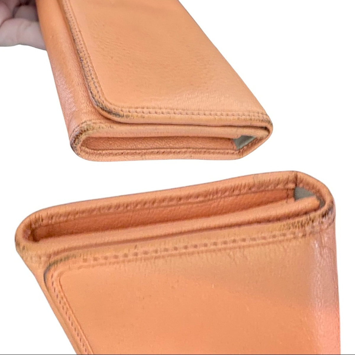 An orange leather wallet shown in two views on a white background: both showing sides and edges with scuffs