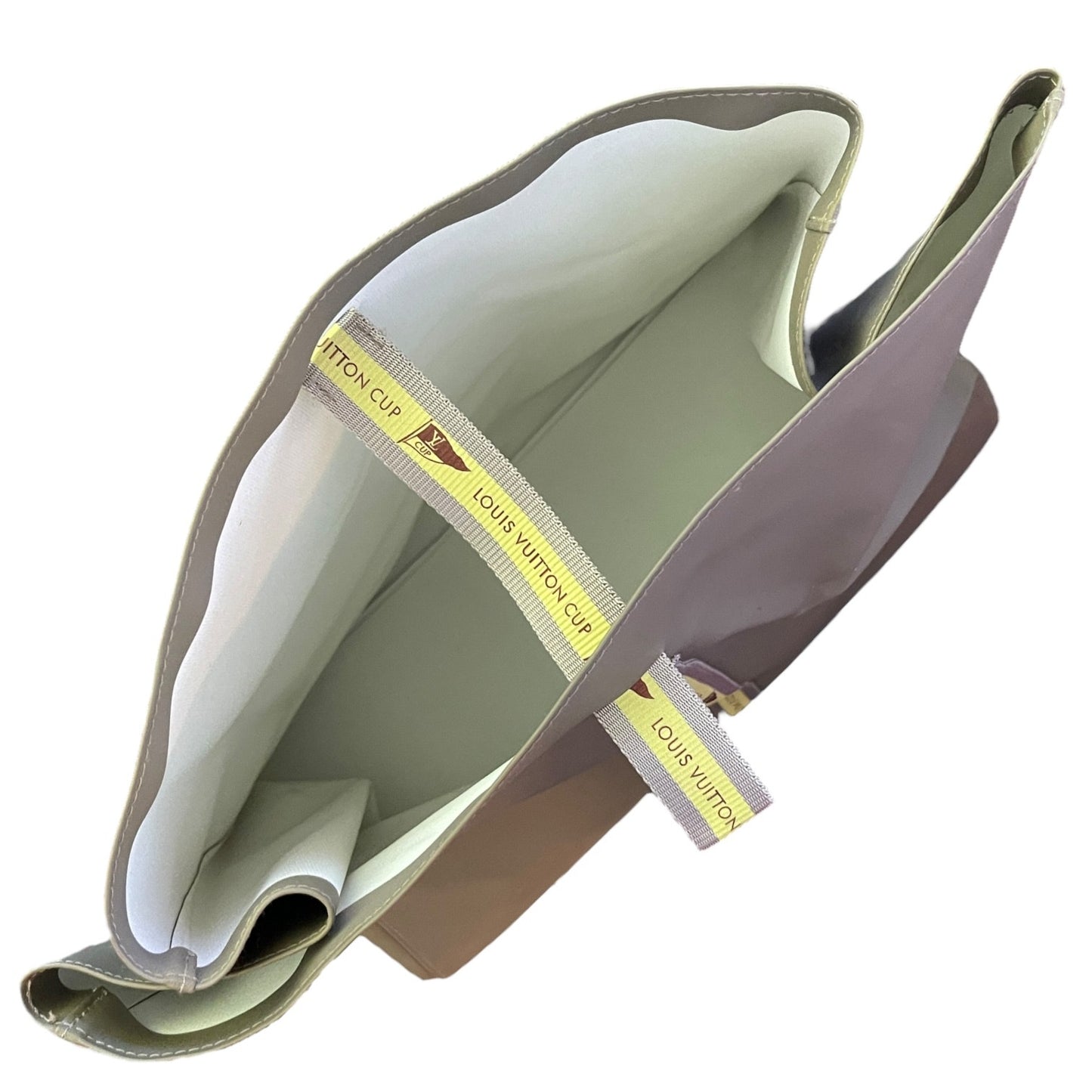 Top of Louis Vuitton tote with a white interior on a white background