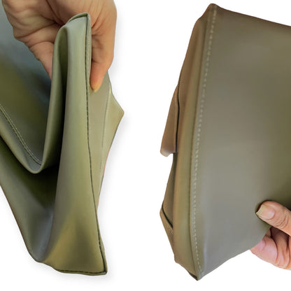 Two hands holding a grayish green tote showing corner against a white background