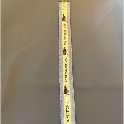 Louis Vuitton cup tote with yellow label on a gray background