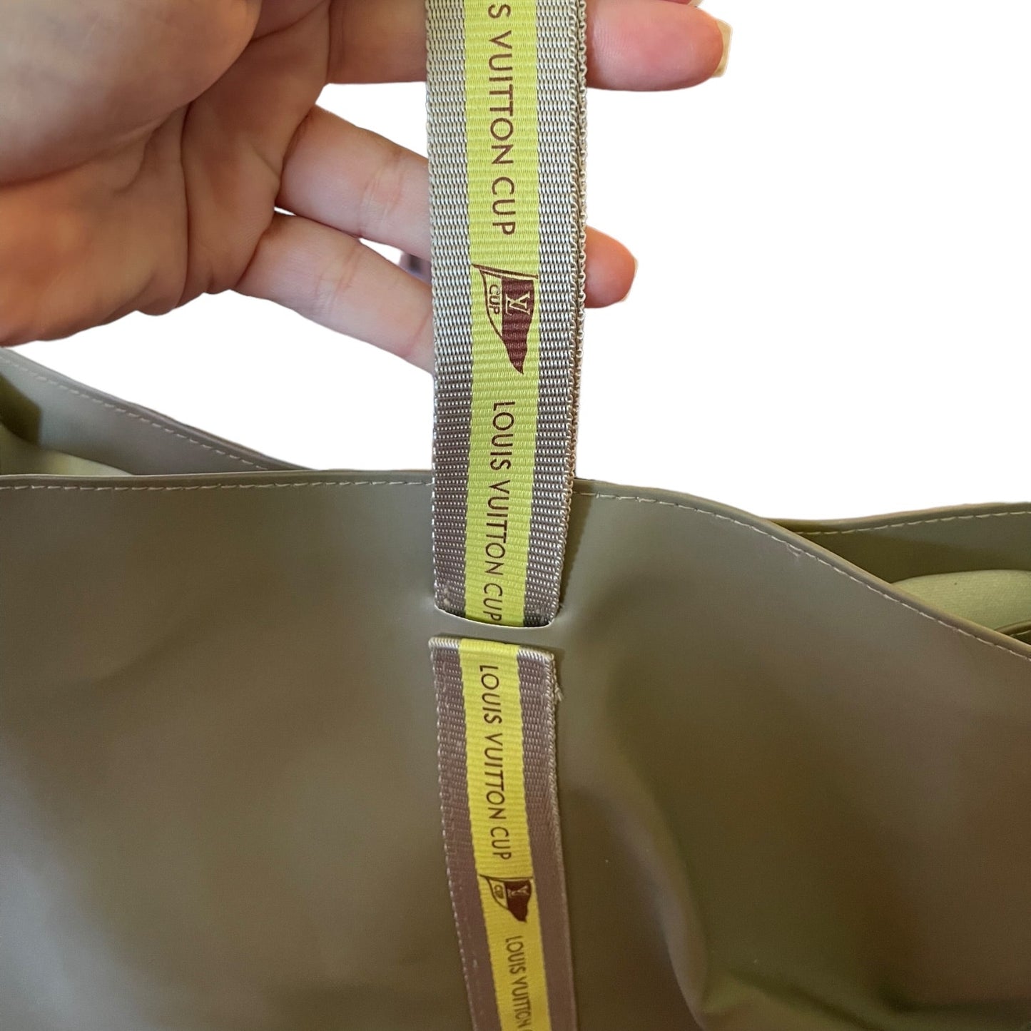 Close-up of a Louis Vuitton bag with a strap, showing the brand logo.