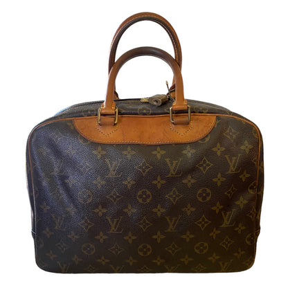 Back of Designer handbag with monogram pattern on a white background