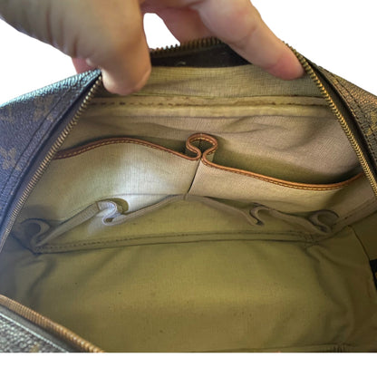 Hand opening a brown purse showing interior  with a white background