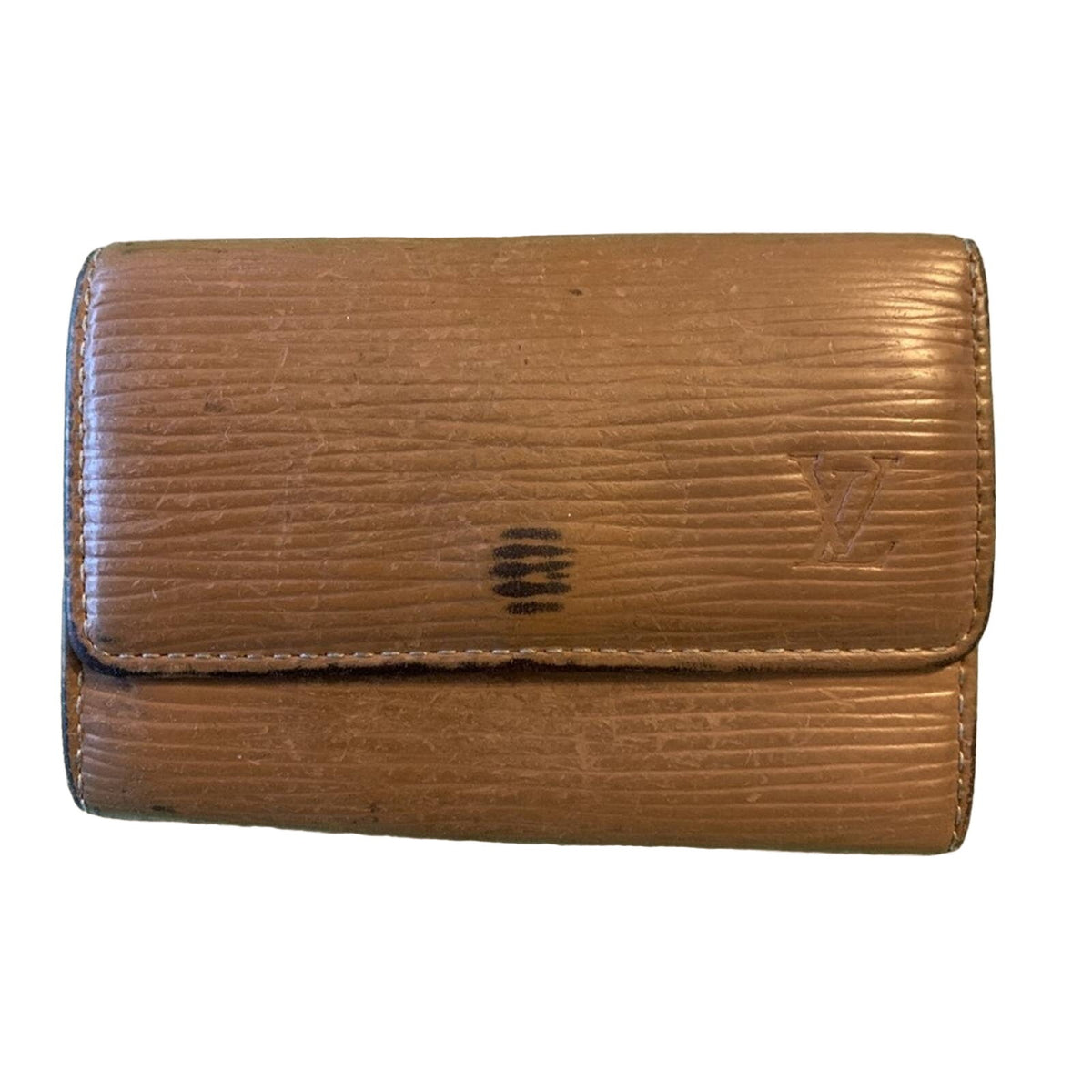 A brown textured leather wallet with a visible embossed Louis Vuitton monogram on the right side and a dark logo mark on the center, shown against a plain white background.