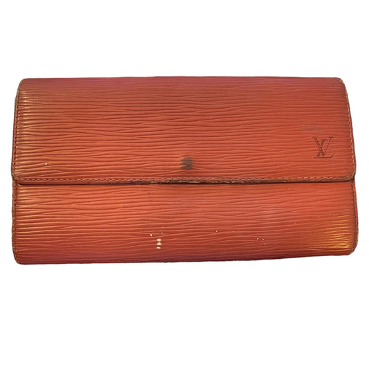 A vintage Louis Vuitton Epi leather clutch wallet in a reddish-brown color, featuring the embossed LV logo on the right side of the flap.