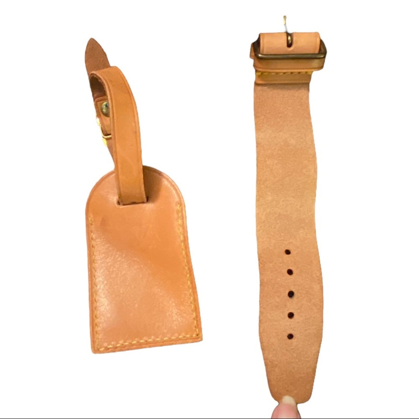 Brown leather strap with a rectangular tag on a white background