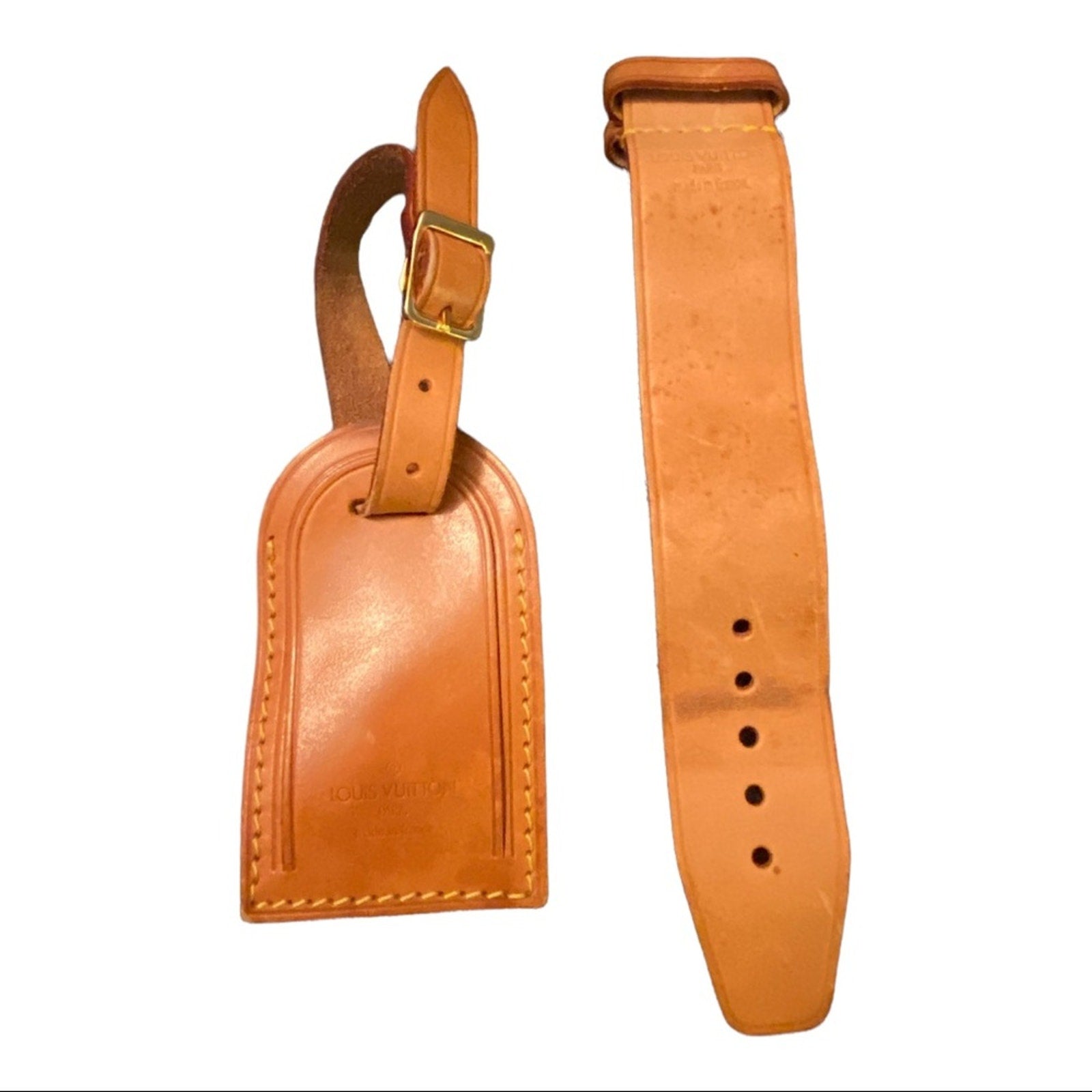 Brown leather luggage tag and strap on a white background