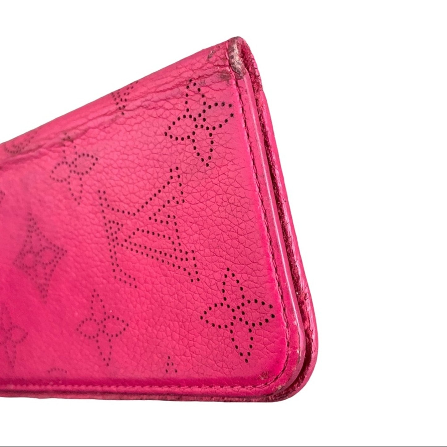 Close-up of a pink cellphone case with a pattern showing corners and edges on a white background