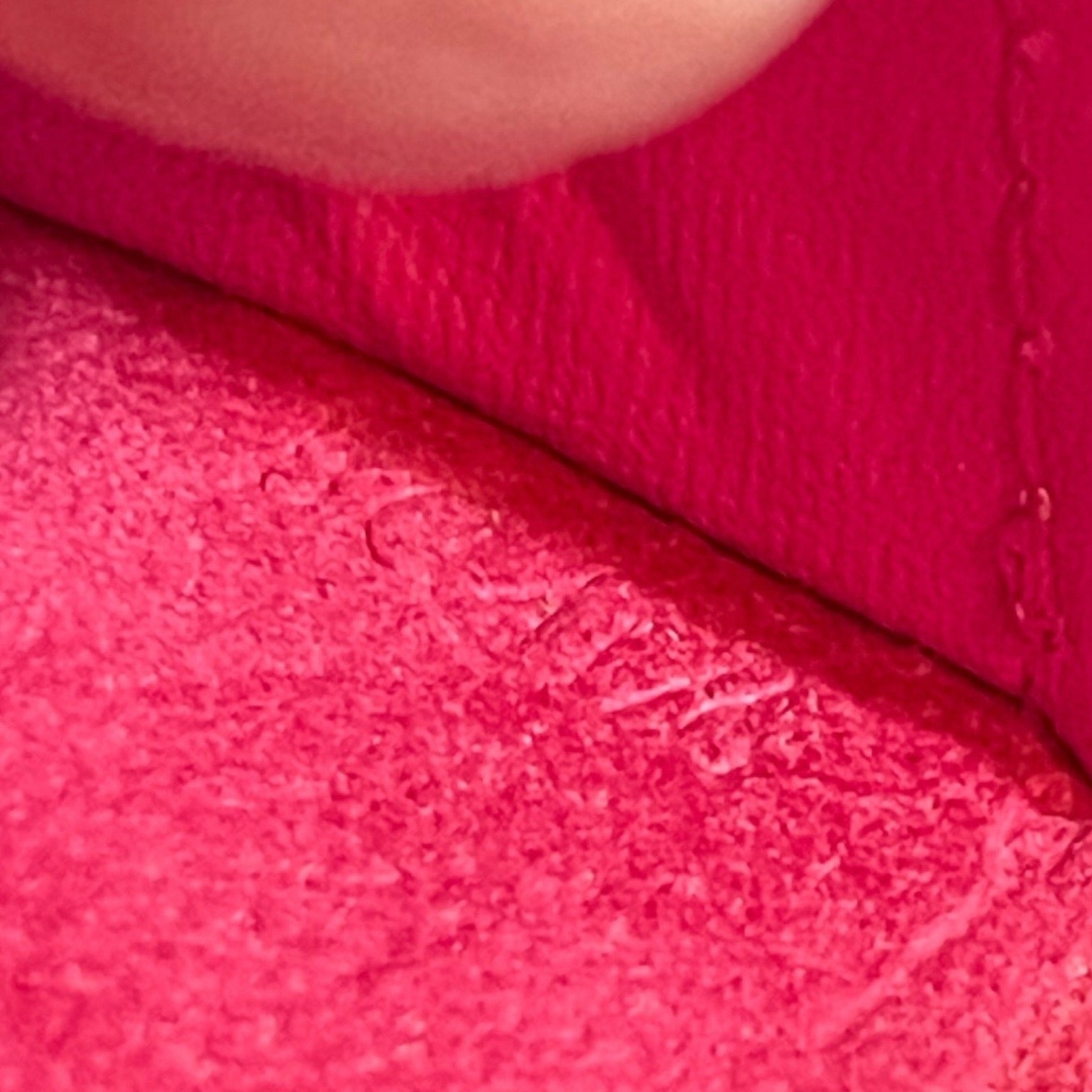 Close-up of pink textured fabric with date code