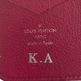 Close-up of a pink Louis Vuitton wallet with initials K.A.
