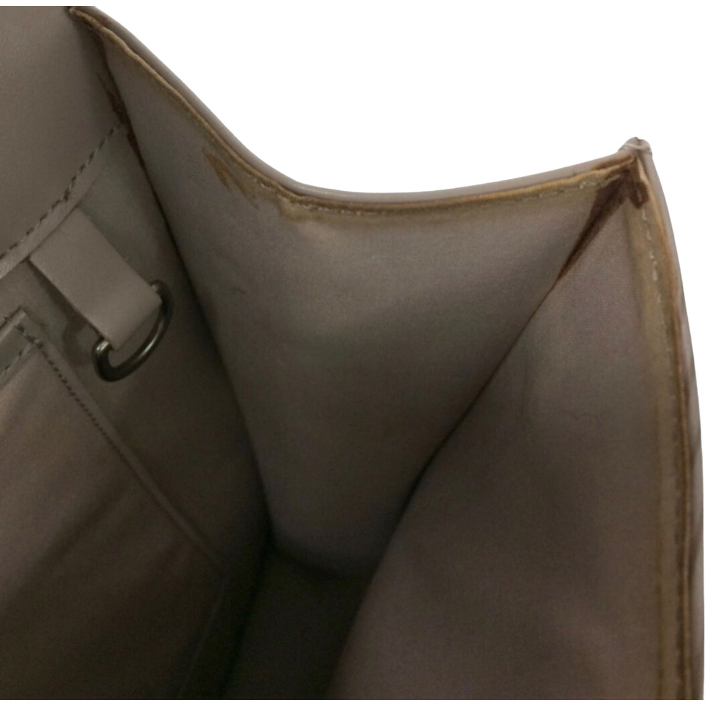 Interior of purse showing discoloration and stains