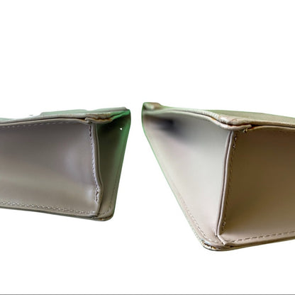 Corner view of purple handbag on a white background