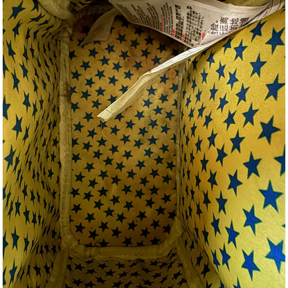 Yellow fabric with blue star pattern and a interior tag