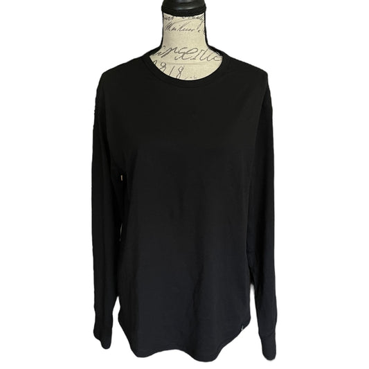 Black long-sleeve top on a mannequin against a white background