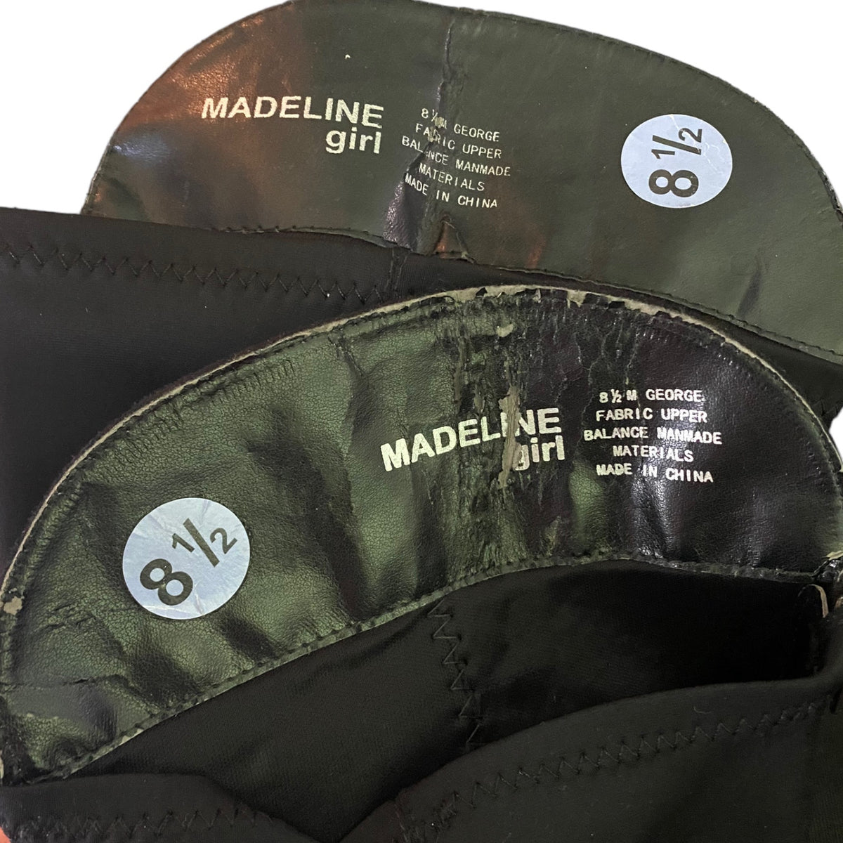 Close-up of the interior of boots with a peeling issues with 'MADELINE girl' and size sticker '8 1/2'.