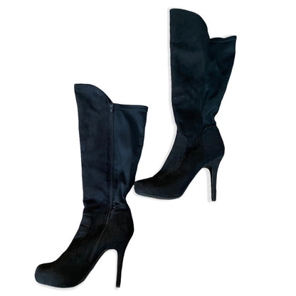 A pair of black knee-high heeled boots with a side zipper, shown against a plain white background.