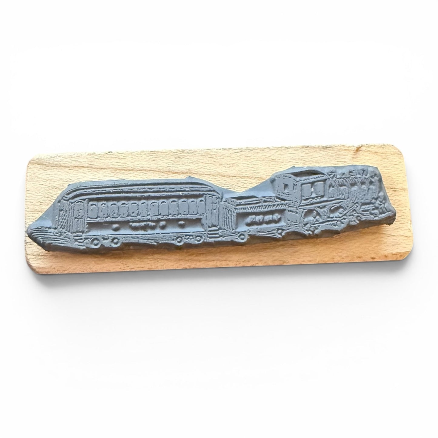 Gray train rubber stamp on a wooden board with a white background