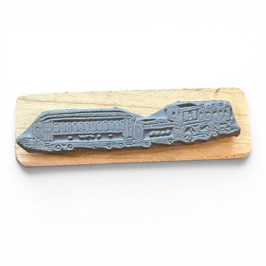 Gray train rubber stamp on a wooden board with a white background