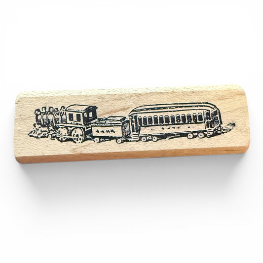 Wooden stamp with a train design on a white background