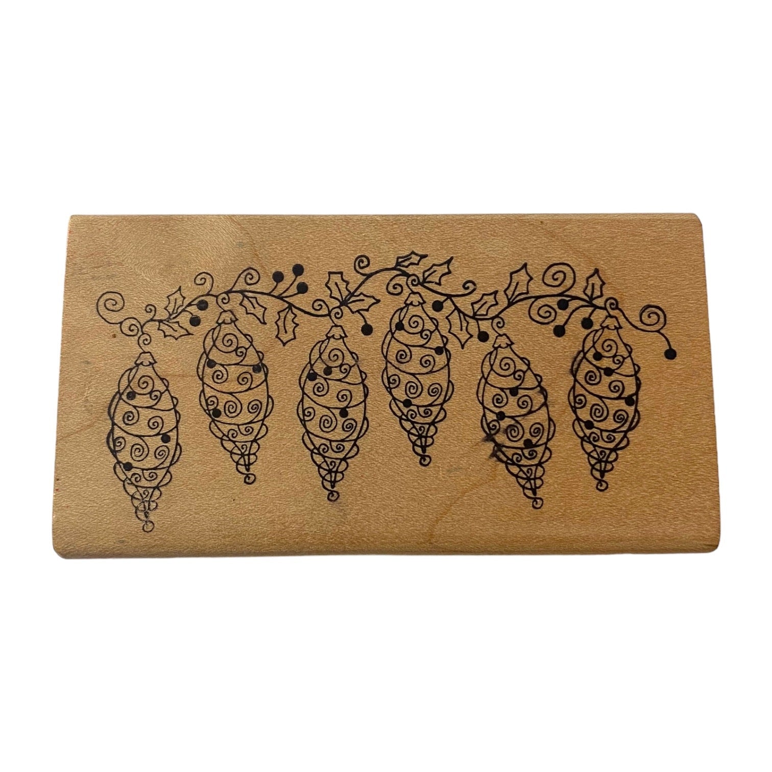 Wooden stamp with decorative design on a white background