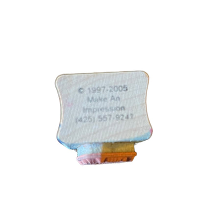 Small rectangular block with text and a phone number on a white background