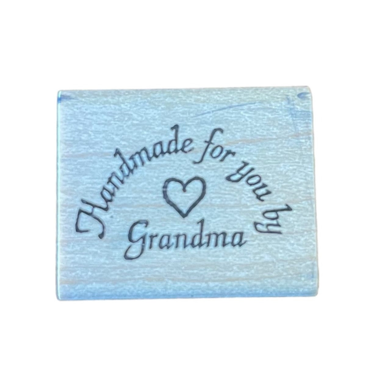 Wood block with 'Handmade for you by Grandma' text on a white background