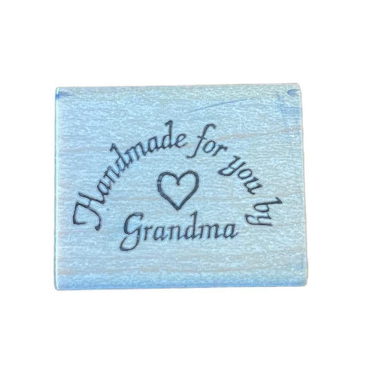Wood block with 'Handmade for you by Grandma' text on a white background