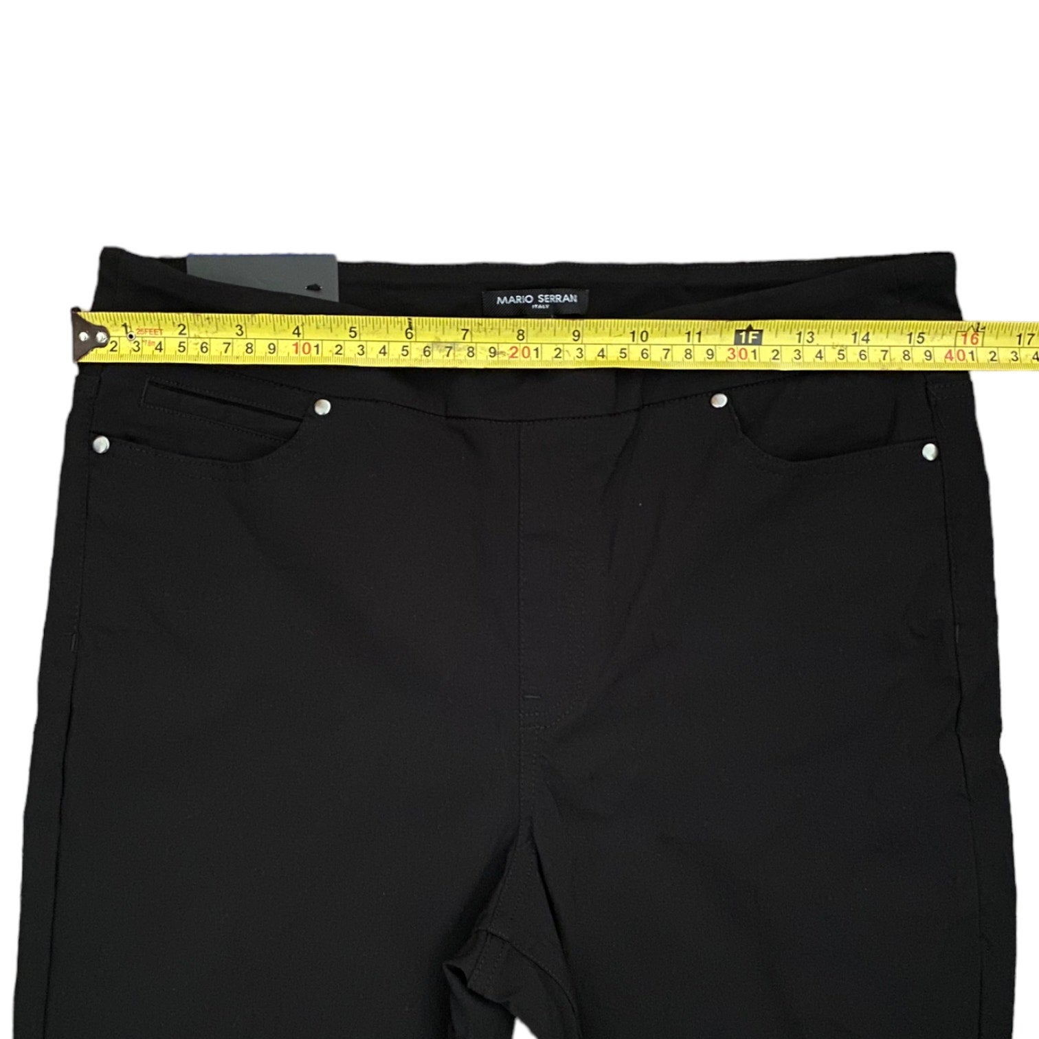 Black pants with a measuring tape on a white background