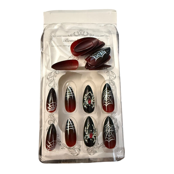 Set of Halloween-themed false nails in a clear packaging on a white background