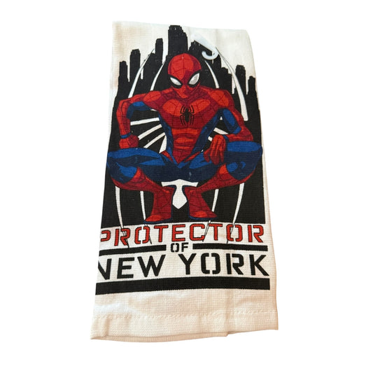 A towel featuring a graphic of Spider-Man crouching with the text 'PROTECTOR OF NEW YORK' printed below, set against a plain white background.