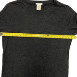 Black t-shirt with a measuring tape across it, showing size measurement.