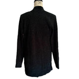 Back of cardigan sweater on a mannequin against a white background