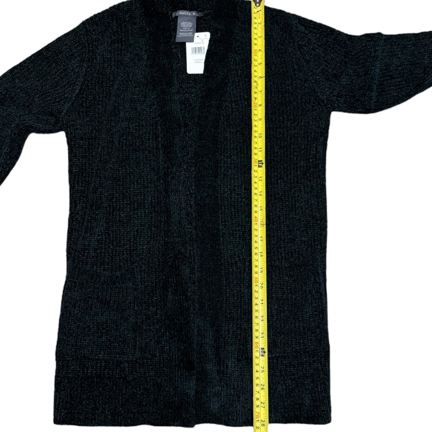 Green cardigan with a yellow measuring tape on a white background