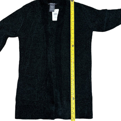 Green cardigan with a yellow measuring tape on a white background