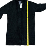 Green cardigan with a yellow measuring tape on a white background