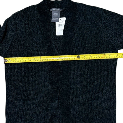 Green sweater with a measuring tape around it, on a white background