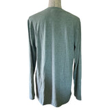 Back of green long-sleeve shirt on a mannequin against a white background