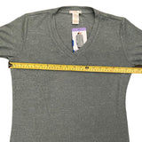 Green t-shirt with a measuring tape across it on a white background
