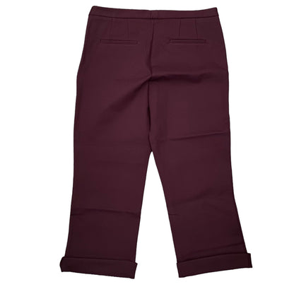 A pair of women's capri pants in a deep burgundy color, shown from the back with rolled cuffs and welt pockets on the upper legs, set against a plain white background.