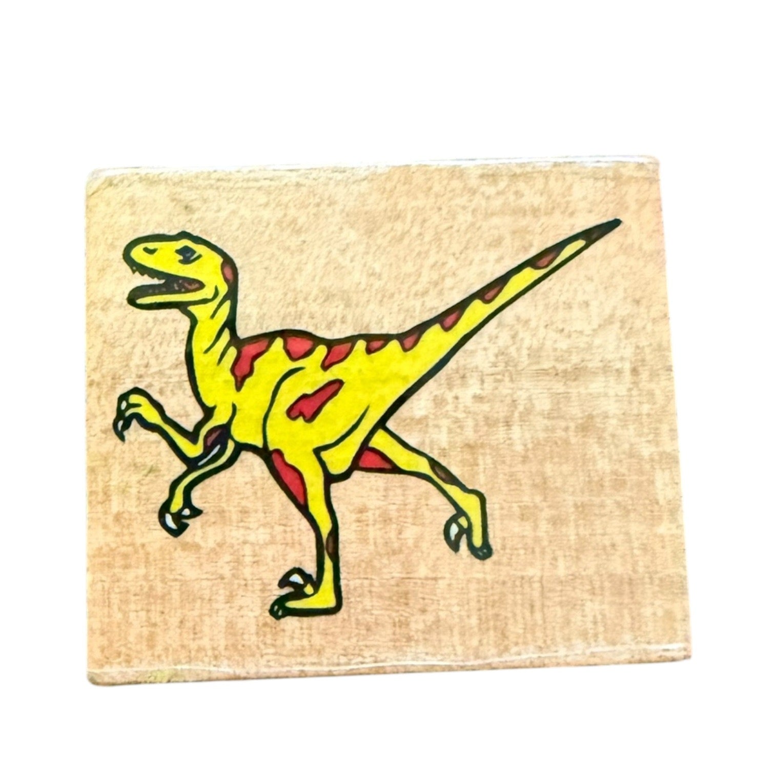 Yellow dinosaur illustration on a beige block